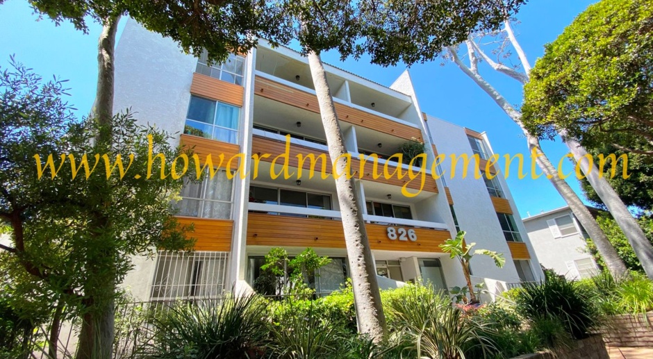 Elegant upper condo with balcony and fireplace walking distance to the beach.